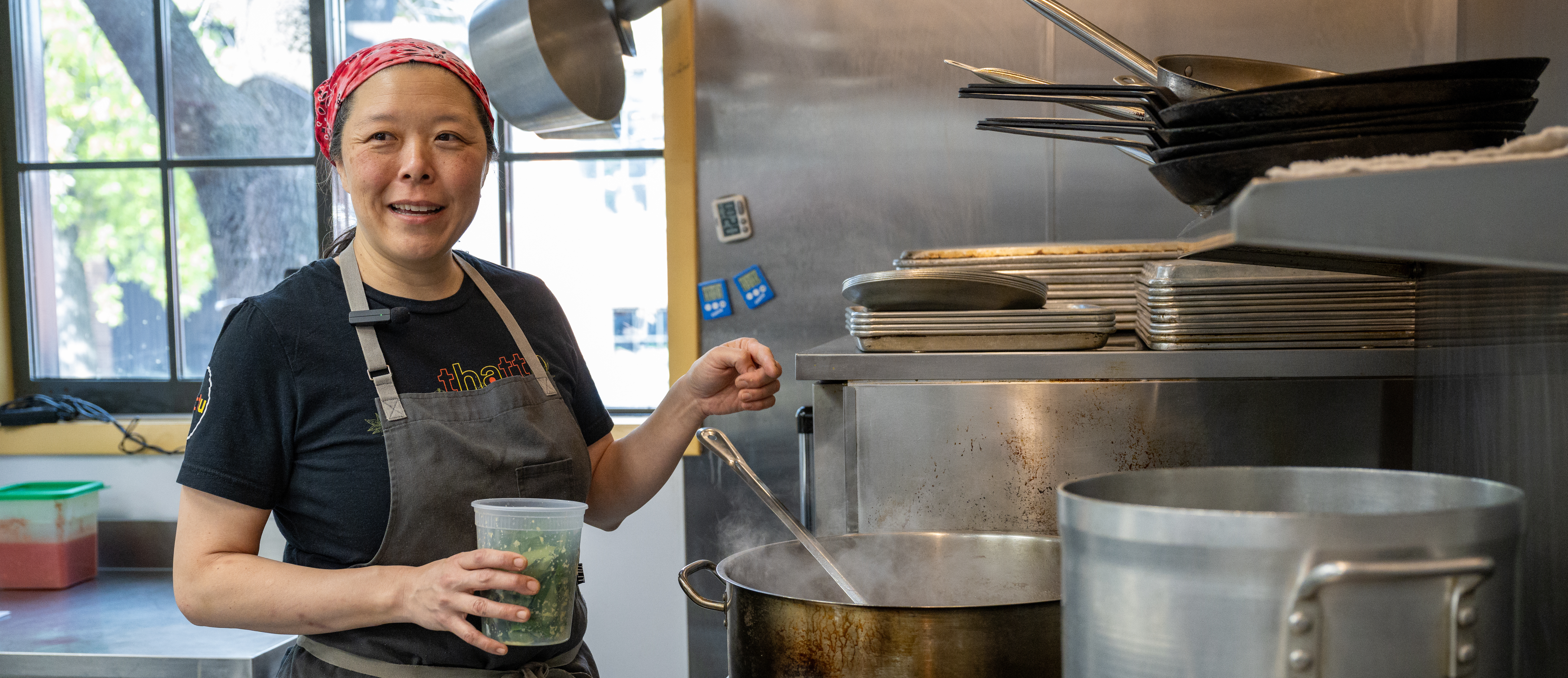 Margaret Pak cooking over stove